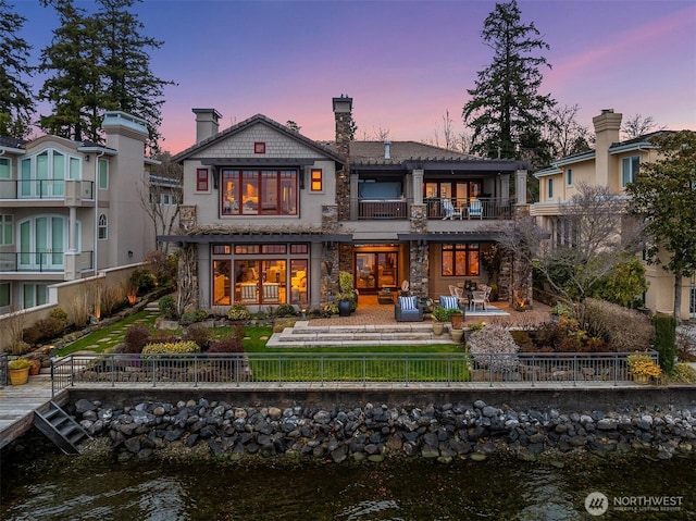 137 Lake Ave W, Kirkland, WA 98033 - back of house with fence private yard, a water view, a patio, stone siding, and a balcony