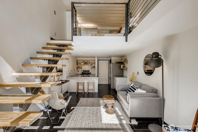 staircase featuring a towering ceiling