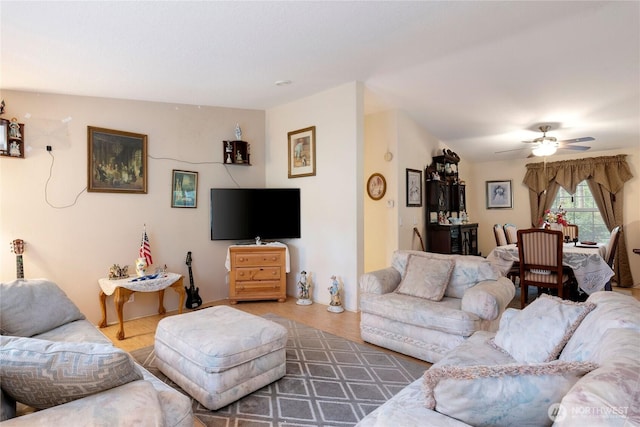living area featuring a ceiling fan