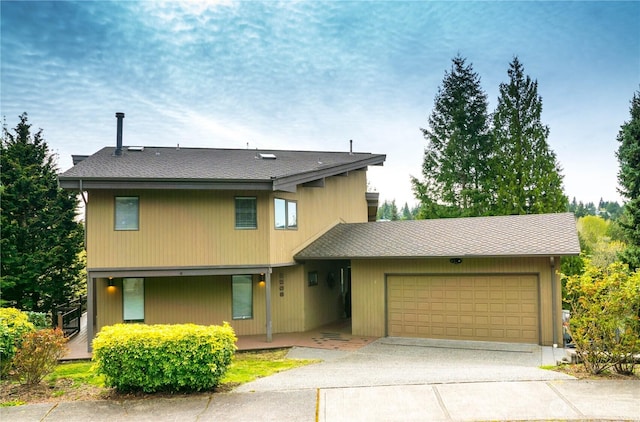 2205 135th Pl SE, Bellevue, WA 98005 - view of front of home featuring a garage, concrete driveway, and covered porch