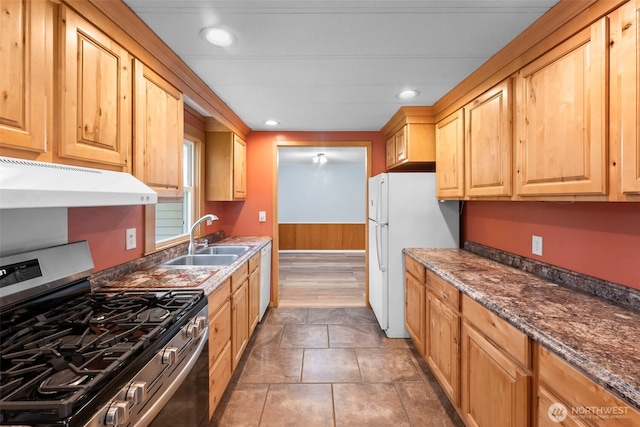 24709 148th Ave E, Graham, WA 98338 - kitchen featuring stainless steel gas stove, a sink, under cabinet range hood, freestanding refrigerator, and light brown cabinets