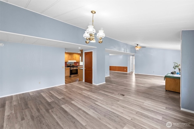 24709 148th Ave E, Graham, WA 98338 - unfurnished living room with a chandelier, light wood-style flooring, and baseboards