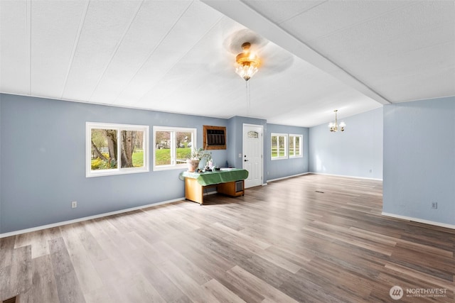 24709 148th Ave E, Graham, WA 98338 - unfurnished living room with a chandelier, wood finished floors, and healthy amount of natural light