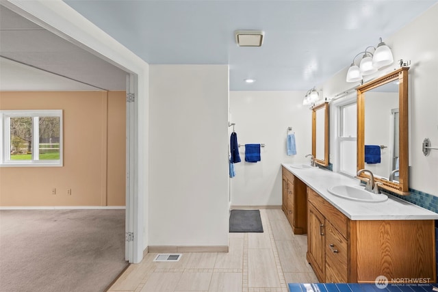 24709 148th Ave E, Graham, WA 98338 - bathroom featuring baseboards and double vanity