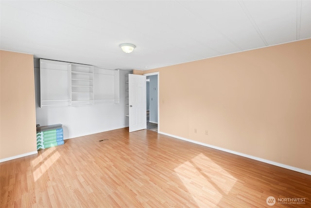 24709 148th Ave E, Graham, WA 98338 - unfurnished bedroom featuring wood finished floors and baseboards