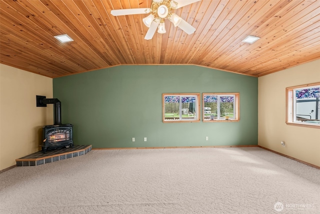 24709 148th Ave E, Graham, WA 98338 - unfurnished living room with a wood stove, vaulted ceiling, plenty of natural light, carpet floors, and wood ceiling