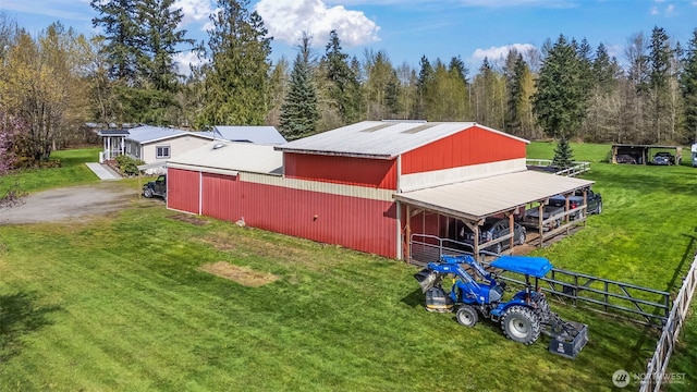 24709 148th Ave E, Graham, WA 98338 - view of property exterior featuring metal roof, an outbuilding, and an exterior structure