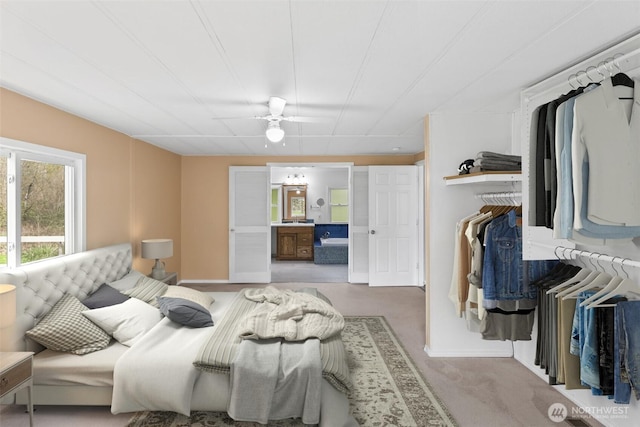 24709 148th Ave E, Graham, WA 98338 - bedroom featuring connected bathroom, ceiling fan, and carpet