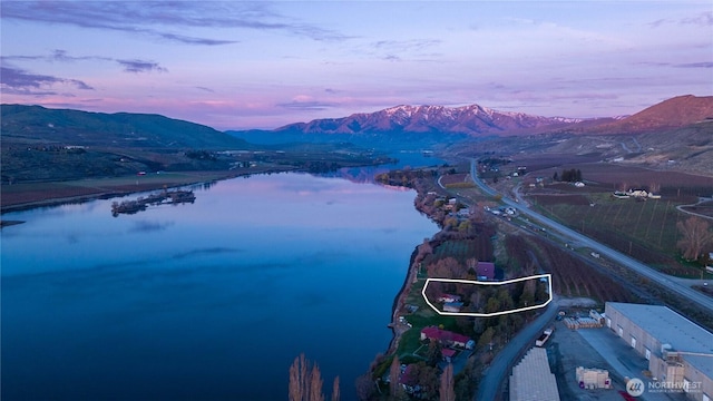 birds eye view of property with a water and mountain view