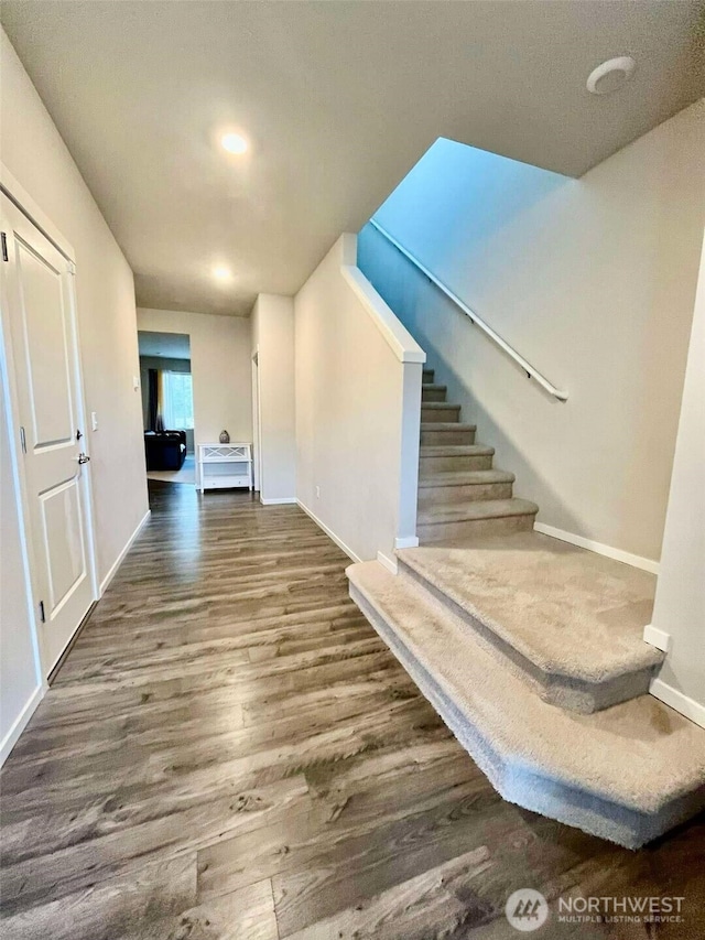 interior space featuring wood finished floors and baseboards