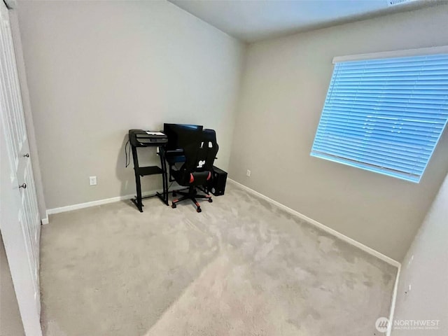 office space with carpet flooring and baseboards