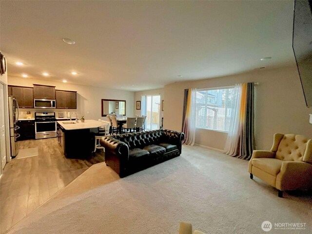 living area featuring recessed lighting and light wood-type flooring