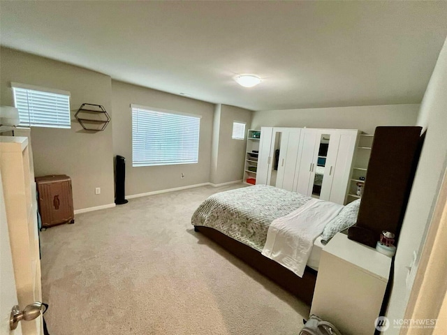 bedroom with baseboards and carpet
