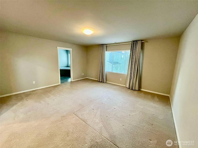 carpeted spare room with baseboards