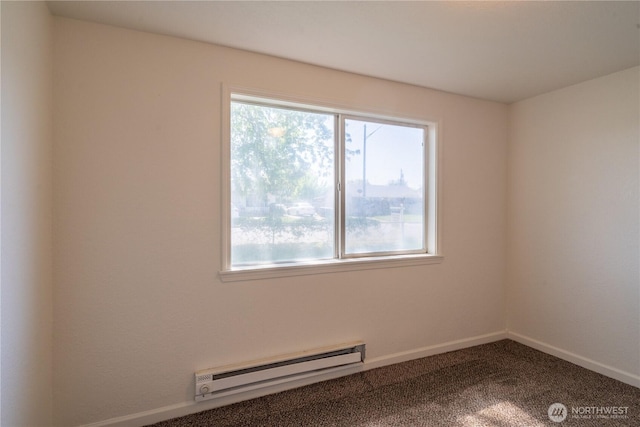 unfurnished room with a baseboard heating unit, baseboards, a healthy amount of sunlight, and carpet