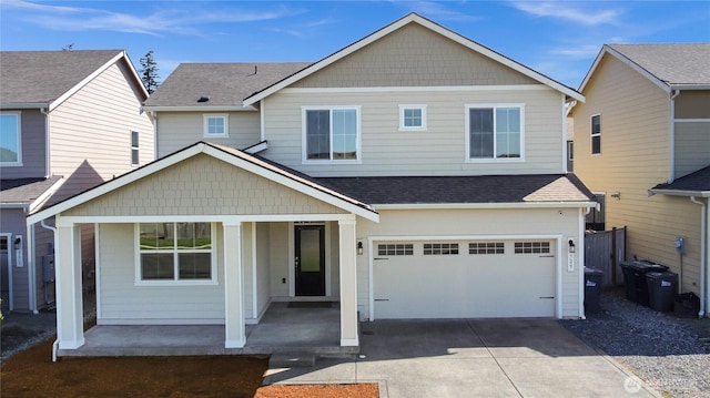 view of front facade with a garage, a shingled roof, concrete driveway, and a porch
