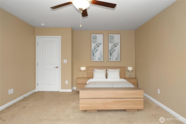 bedroom with a ceiling fan, baseboards, and light colored carpet