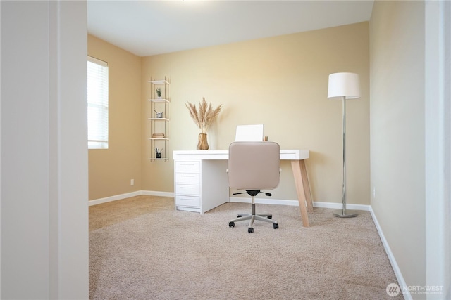 carpeted office space featuring baseboards