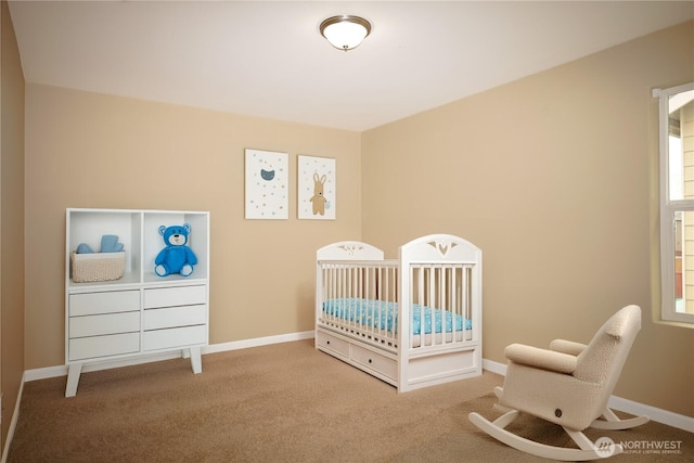 bedroom with carpet floors, baseboards, and a nursery area