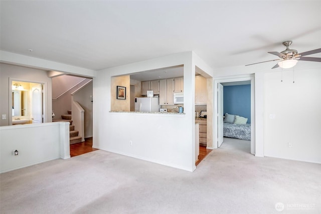 4802 Nassau Ave NE Unit 45, Tacoma, WA 98422 - unfurnished living room featuring a ceiling fan, light carpet, and stairs