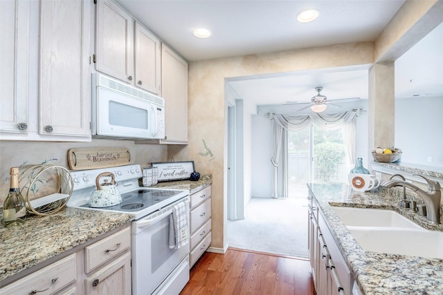 4802 Nassau Ave NE Unit 45, Tacoma, WA 98422 - kitchen with ceiling fan, white appliances, light stone countertops, wood finished floors, and a sink