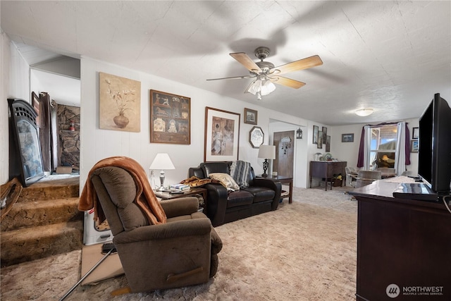 living area with ceiling fan and carpet floors