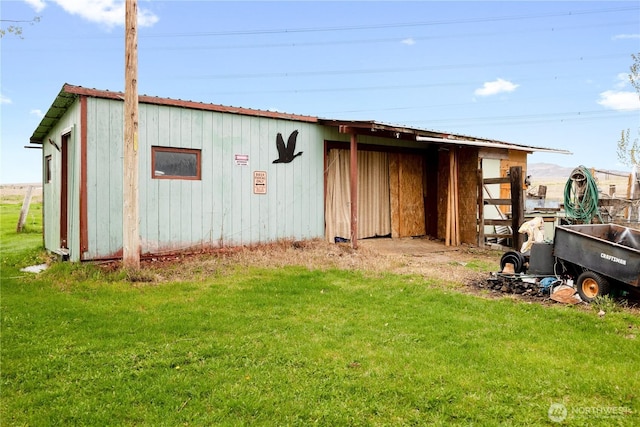 view of pole building with a yard