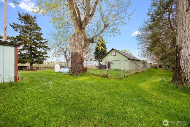 view of yard with fence and a gate