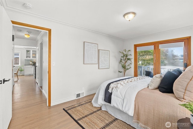 bedroom featuring visible vents, french doors, light wood-style floors, crown molding, and baseboards