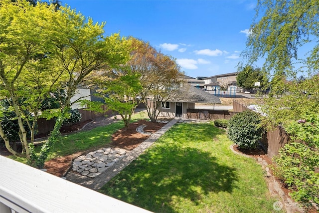 view of yard with an outdoor structure and a fenced backyard