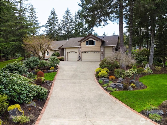 view of front of home featuring driveway, a garage, and a front lawn