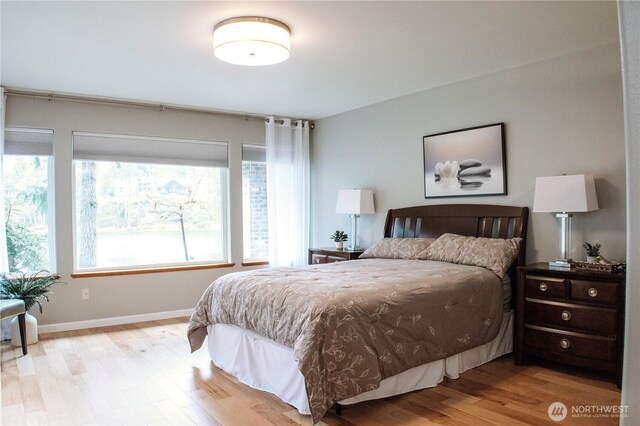 bedroom featuring light wood-style flooring and baseboards