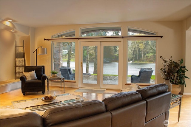 living room with a water view and wood finished floors