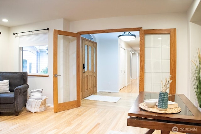 hallway featuring baseboards and wood finished floors