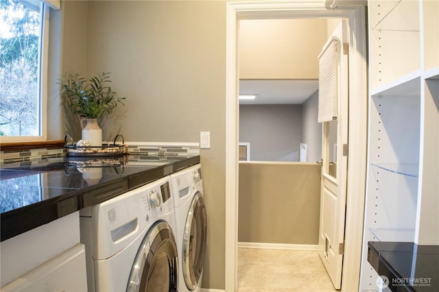 laundry area featuring independent washer and dryer and a wealth of natural light