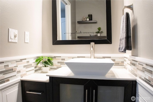 bathroom featuring tasteful backsplash and vanity