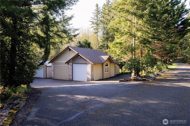 view of front of house with an outbuilding and a detached garage