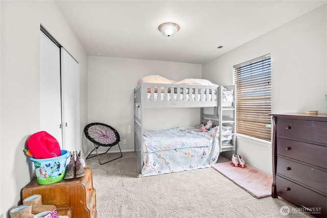 carpeted bedroom featuring baseboards