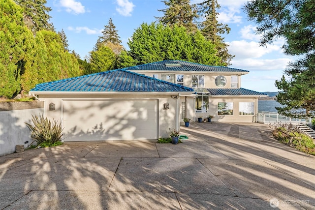 1192 E State Route 4, Cathlamet, WA 98612 - view of front of home featuring stucco siding, a garage, driveway, and fence