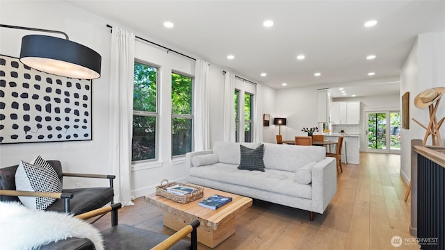 living room with recessed lighting, light wood finished floors, and a healthy amount of sunlight