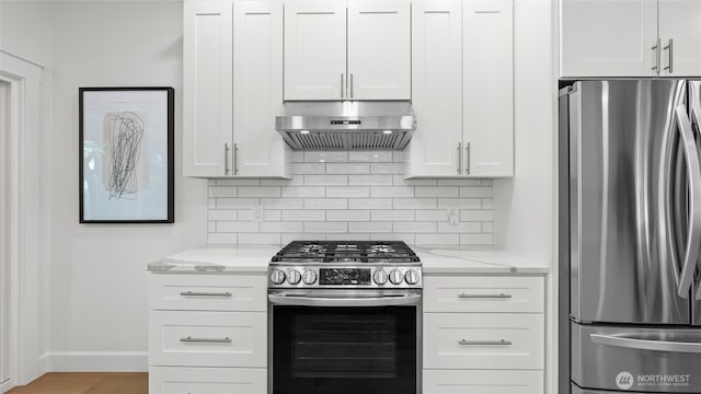 kitchen with baseboards, extractor fan, light stone counters, appliances with stainless steel finishes, and backsplash