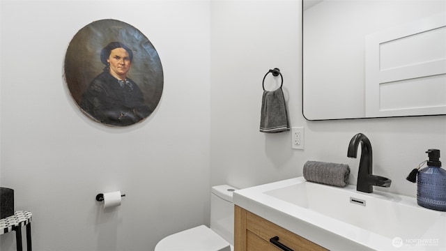 bathroom featuring toilet and vanity