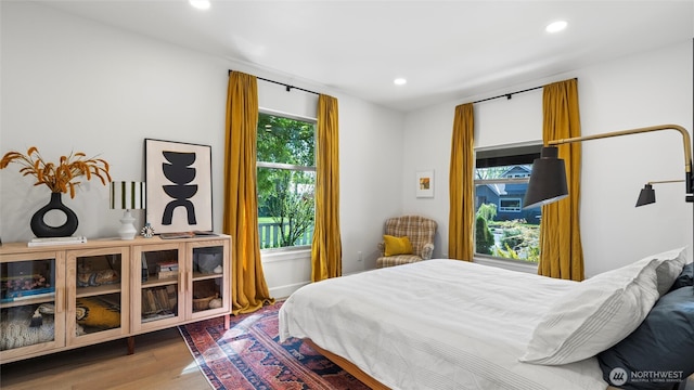 bedroom with recessed lighting and wood finished floors