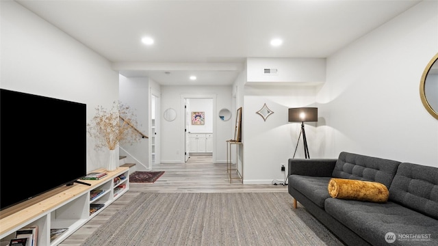 living area with stairs, recessed lighting, baseboards, wood finished floors, and visible vents