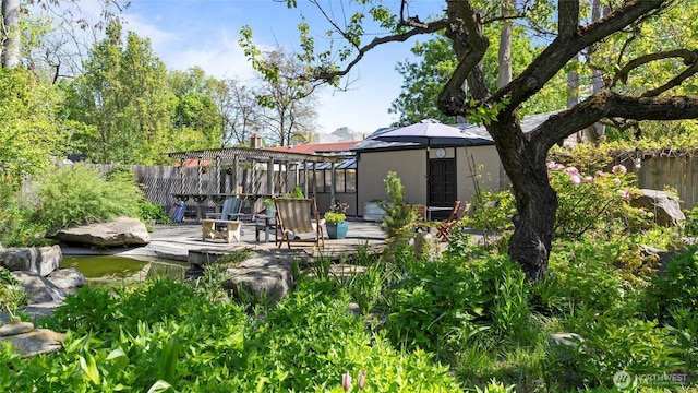 exterior space with stucco siding, fence, and a patio