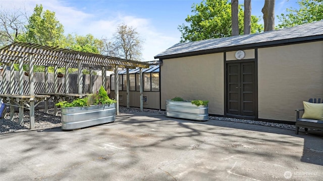 view of patio featuring fence and a pergola