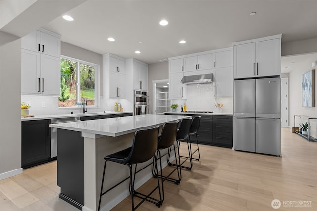 18116 83rd Ave NE, Kenmore, WA 98028 - kitchen featuring wall chimney range hood, a center island, recessed lighting, and stainless steel appliances