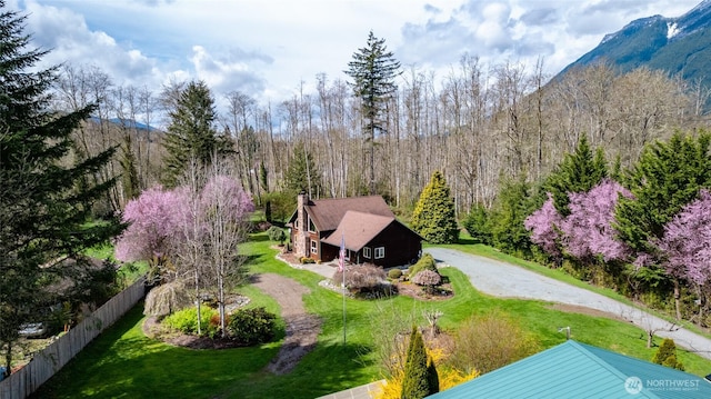 birds eye view of property with a forest view and a mountain view