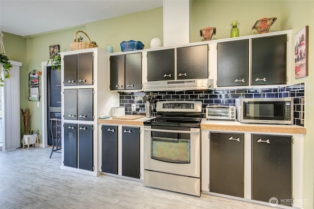 kitchen with light countertops, appliances with stainless steel finishes, under cabinet range hood, backsplash, and a toaster