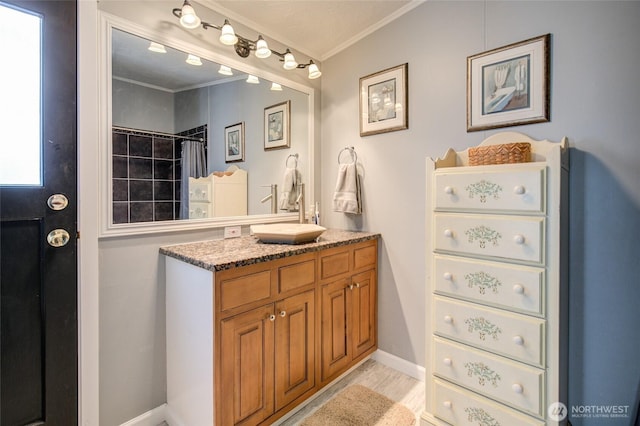 bathroom with curtained shower, vanity, baseboards, and ornamental molding